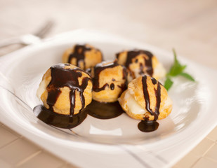 Profiteroles with cream and chocolate.