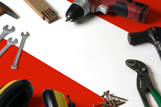 Austria flag on repair tool concept wooden table background. Mechanical service theme with national objects.