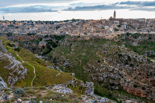 Amazing distant panoramic view of Matera and Matera Canyon from Parco della Murgia Materana or Park of the Rupestrian Churches of Matera in the Province of Matera, Basilicata Region, Italy