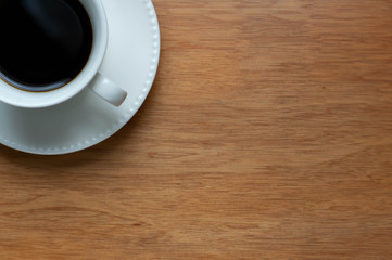 cup of coffee on a wooden background
