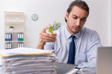 Young male businessman employee unhappy with excessive work