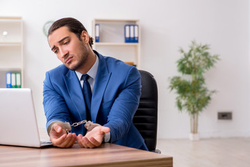 Young male businessman employee working in the office