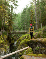 Fototapeta premium man posing in lush green landscape, Washington