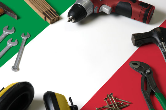 Italy flag on repair tool concept wooden table background. Mechanical service theme with national objects. - Powered by Adobe