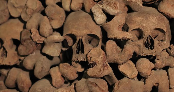 Wall made of human bones, shadows moving around