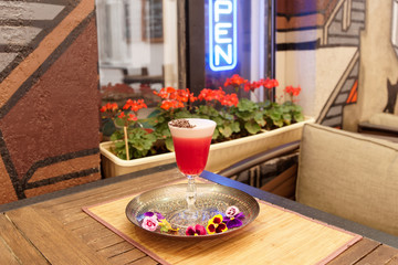 Red cocktail with froth and chocolate shaving