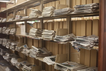 SEVERAL ROWS OF NEWSPAPER ON A WALL