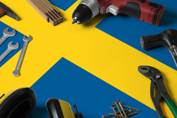 Sweden flag on repair tool concept wooden table background. Mechanical service theme with national...