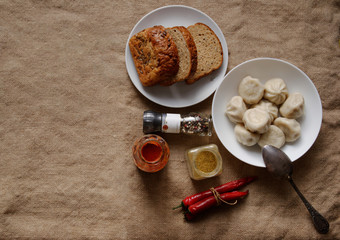 khinkali on the table with ketchup, pepper, bread and chili. Bon Appetit.