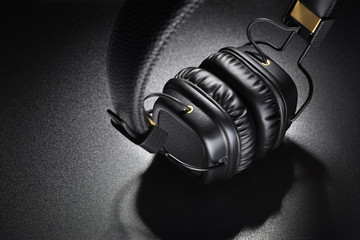 Fototapeta na wymiar Wireless on-ear headphones on black background