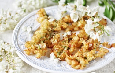 flowers of white acacia in batter. organic food from nature. natural habitat. Edible flowers. foraging