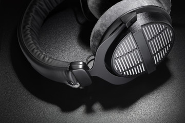 Black studio headphones on dark background