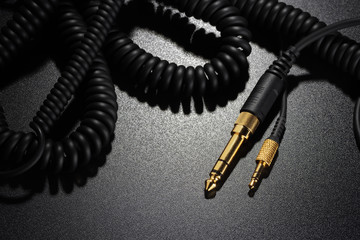 Jack connectors and audio cables on black background
