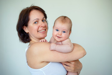 Happiness maternity concept. Mom and baby at home.