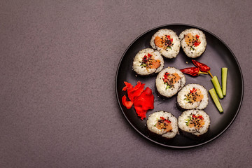 Korean roll Gimbap(kimbob). Steamed white rice (bap) and various other ingredients. Trendy black background