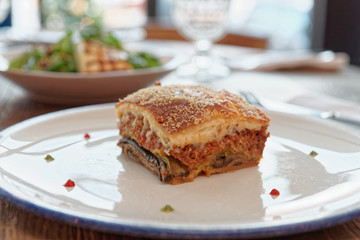 Piece of moussaka on restaurant table