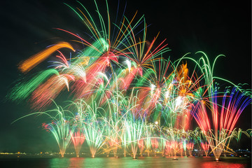 Multicolored bright festive fireworks on the background of the evening sky