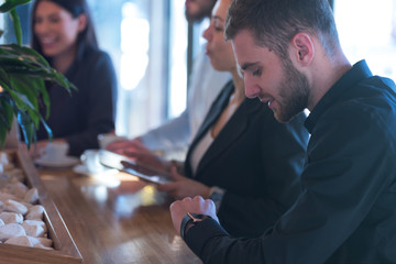Young business people talking with each other about new projects at a coffee bar