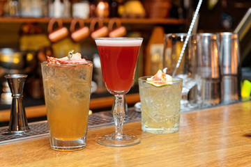 Three cocktails sitting on bar counter
