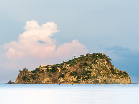 Morning light over a small island in front of a beach on the Caribbean coast.