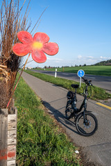 DANIKON, SWITZERLAND - APRIL 18, 2020: The artificial flower creates a cozy atmosphere along the cycle path between Regensdorf and Baden.