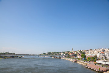 Fototapeta na wymiar View of Sava river bank in Belgrade. An orthodox cathedral church can be seen on the right, Kalemegdan fortress on the background, and brankov most bridge in front