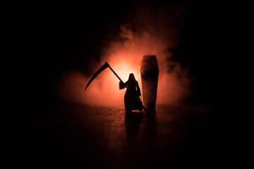 Death with a scythe in the dark misty forest. Woman horror ghost holding reaper in forest,...