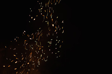 Group of flying sparks in the black background