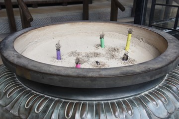 They're daily manners to offer incense stick(japanese called Senko )at worship in a temple in Japan.