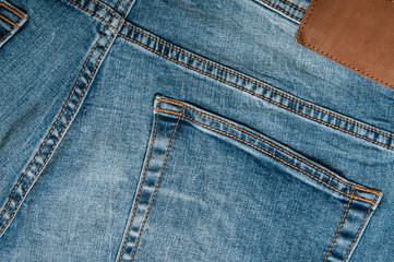 Denim pants in blue on a wooden background