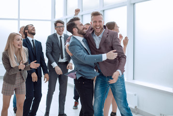 jubilant group of employees meeting the boss of the winner