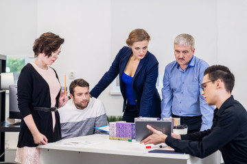 A group of five people brainstorming in the office