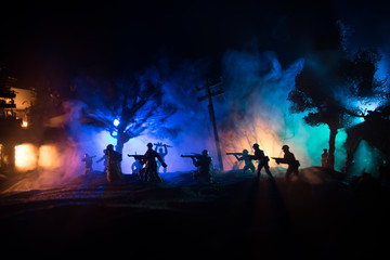 Fototapeta na wymiar War Concept. Military silhouettes fighting scene on war fog sky background, World War Soldiers Silhouette Below Cloudy Skyline At night.