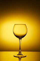 empty wine glasses on yellow