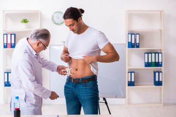 Doctor dietician giving advices to fat overweight patient