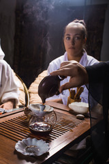 Tea ceremony after the sauna. Girls in white coats drink Chinese tea