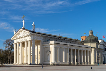 The main church in Lithuania - the Cathedral Basilica of St Stanislaus and St Ladislaus of Vilnius from the southwest side in the Cathedral Square on a sunny spring evening - obrazy, fototapety, plakaty
