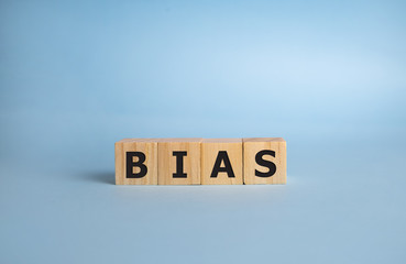 Bias - word from wooden blocks with letters, personal opinions prejudice bias concept, blue...