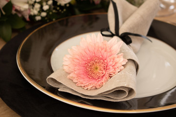 Elegant table setting with flowers and white and black dinnerware