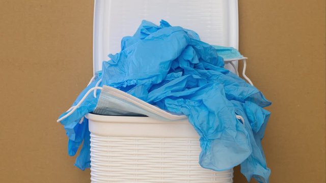 gloves and masks used in the waste bin