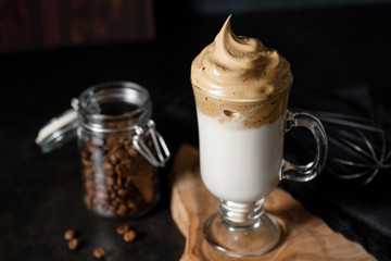 The Korean coffee drink dalgona on dark wooden background