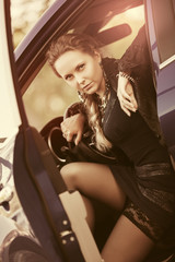 Fototapeta na wymiar Beautiful fashion woman sitting in a car