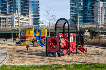 Fototapeta na wymiar Closed playground at empty park during Coronavirus pandemic in Toronto, Ontario, Canada.