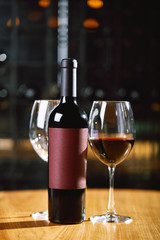 Bottles and glasses with wine on the table. Wine drinking culture concept. Apperetes and survivors. Copy space, dark background