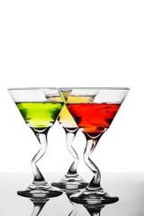 Three alcoholic beverages of red, yellow and green