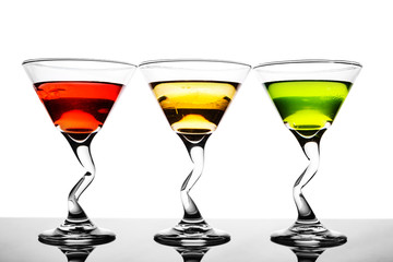 Three alcoholic beverages of red, yellow and green