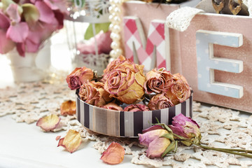 dried roses in a round box