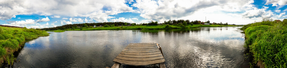 Wooden pier on the river. Countryside view