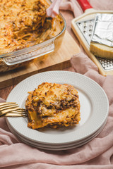 Homemade Cheesy and Meaty Lasagna (Sliced) with  processed cheese on the side