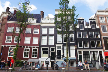 Amsterdam canals and typical houses with clear spring sky